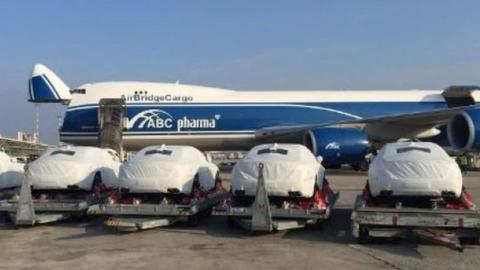 Five Maseratis seen at Port Moresby airport, draped in protective white covers