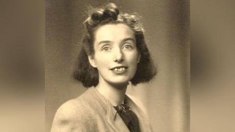 Sepia coloured photo of Judy Fryd as a young woman.