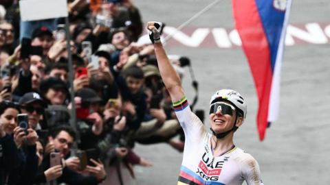 Tadej Pogacar celebrates winning the 2026 Strade Bianche