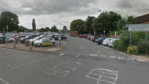 Applegarth car park entrance. Several cars are parked in the car park.