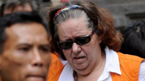 Lindsay Sandiford, in a white shirt and orange vest, arrives at a court in Denpasar on 7 January, 2013