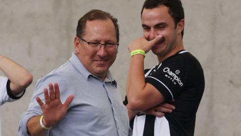 John Textor waves to someone while attending a Botafogo game