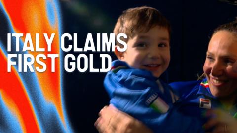 Francesca Lollobrigida celebrates winning gold in the women's 3000m speed skating with her son at the 2026 Winter Olympics