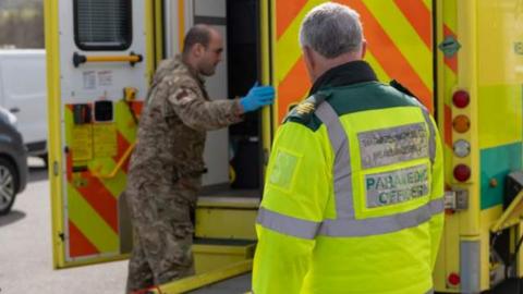 Army soldier being given ambulance training