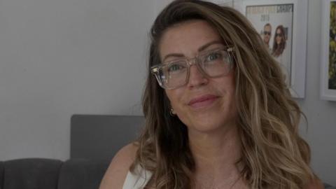 Selina Moss-Davies looking straight at the camera and wearing glasses
