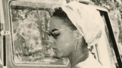 Andrée Blouin wears sunglasses and a headscarf