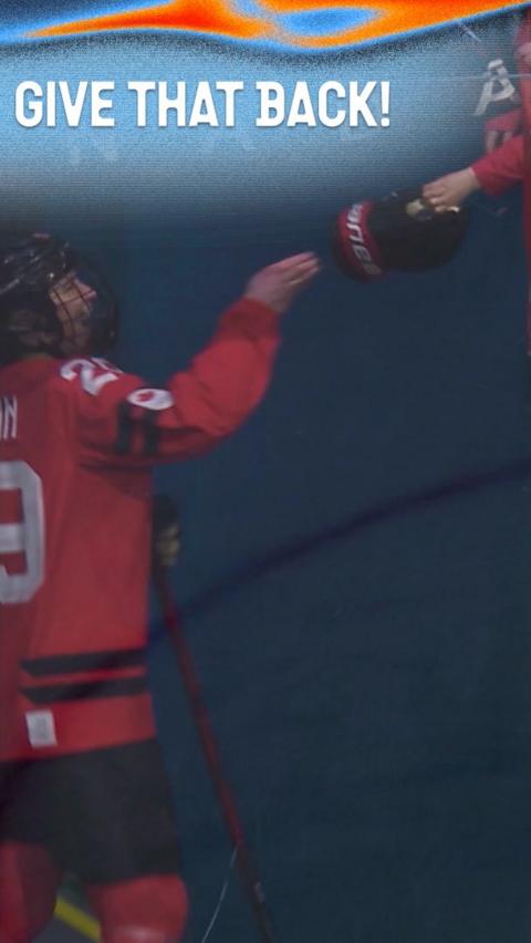 Marie-Philip Poulin has her glove taken off by a fan