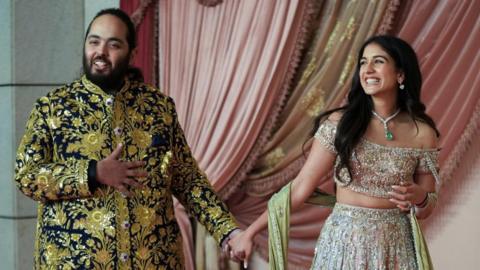 Anant Ambani, son of businessman Mukesh Ambani, arrives with his fiance Radhika Merchant on the red carpet during the sangeet ceremony at Jio World Centre, Mumbai, India, July 5, 2024.