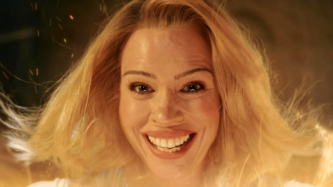 A screengrab from the show - Billie Piper smiles into the camera while yellowish lighting and sparks fly around her hair. She looks emotional and very happy with almost tears in her eyes
