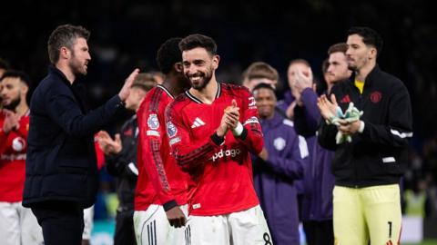 Manchester United skipper Bruno Fernandes (centre) applauds the fans