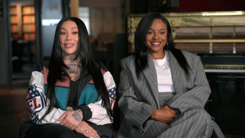 Mutya Buena & Keisha Buchanan from the Sugababes sit smiling at the camera.