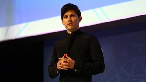 Pavel Durov delivers a keynote address at the Mobile World Congress in Barcelona, Spain in 2016. He has black hair and is wearing a black polo neck jumper.