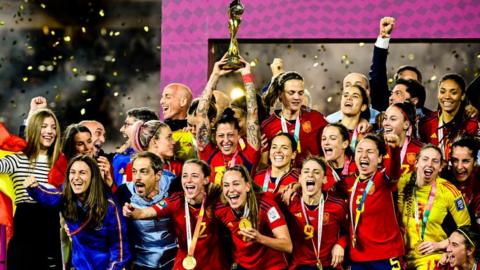 Spain's World Cup winning squad hold the trophy