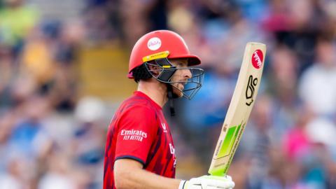 Jos Buttler raises his bat to acknowledge his 50 for Lancashire against Yorkshire at Headingley