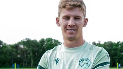 James Connolly poses for a picture in his Walsall training top at the club's training ground.