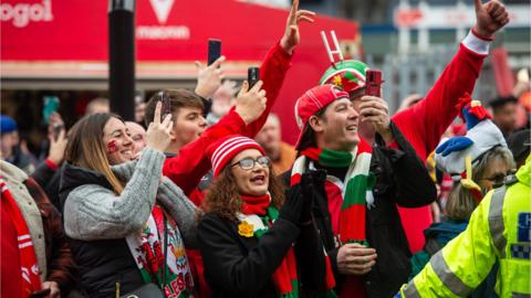 Wales fans wait for the team bus