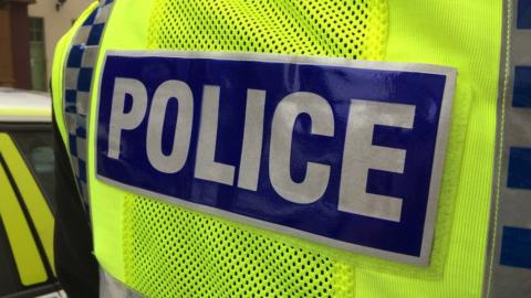 Rear of a police jacket - stock image