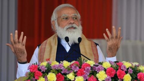 Prime Minister Narendra Modi gestures as he addresses a public meeting at Jerenga Pathar in Sivasagar district of India's Assam state on January 23, 2021.