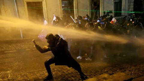  Police officers use water cannons to desperse demonstrators during clashes as part of a protest outside the Parliament building against the government's decision to delay European Union membership talks amid a post-election crisis, in Tbilisi on December 1, 2024.