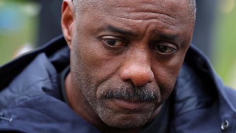 British actor Idris Elba reacts as he highlights an anti-knife crime campaign, near the Houses of Parliament in London