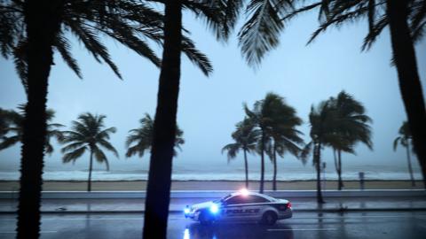 Police patrol the street running along Sebastian Street Beach ahead of the arrival of Hurricane Irma September 9, 2017 in Fort Lauderdale, Florida