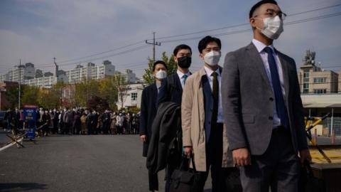 South Korean Jehovah's Witnesses and conscientious objectors to mandatory military service line up to enter a correctional facility to begin training as administrators, in Daejeon on October 26, 2020