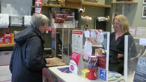 Sue Boulton serves a customers in Moretonhampstead's Post Office