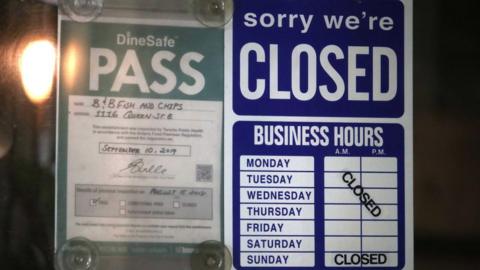 A business in Toronto shows a closed sign even as Ontario begins to slowly emerge from lockdown