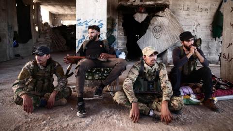 Rebel fighters from the Nur al-Din al-Zinki faction rest in rebel-held Aleppo province (23 September 2018)