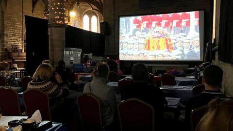 People watching the Queen's funeral on the big screen in Bacup