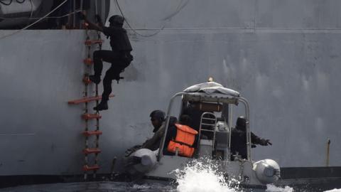 A Nigerian special forces officer climbs aboard a vessel during an anti-piracy exercise, March 2019