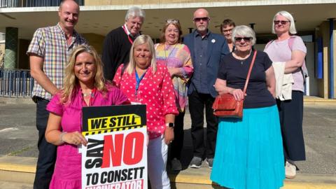 Christine Thomas, chair of the Say No To Consett Incinerator Community Campaign Group, front, with objectors to the proposed energy from waste facility at Consett, outside Durham County Hall.