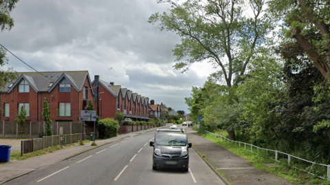 A general view of Mights Road in Southwold, taken from Google Streetview. A van is pictured travelling on one side of the road.