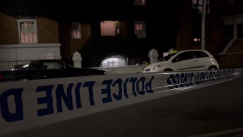 Police tape across a crime scene on Deodar Road, Putney