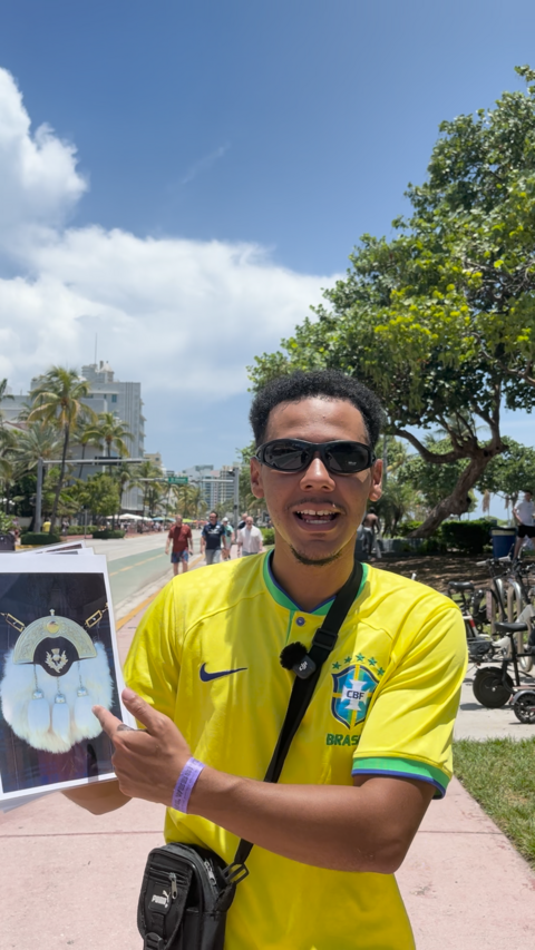 Man in Brazil top holding a picture of a sporran