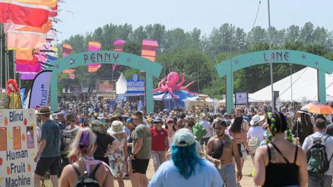 Festival goers walk to the Main Stage at the Isle of Wight Festival at Seaclose Park