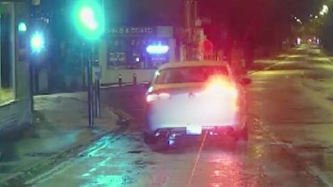 Screengrab from taxi pursuit video shared by Derbyshire Police showing car trying to drive away from officers at high speed