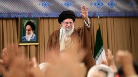 Iran's Supreme Leader Ayatollah Ali Khamenei waves during a meeting with members of Iran's Basij militia in Tehran, Iran