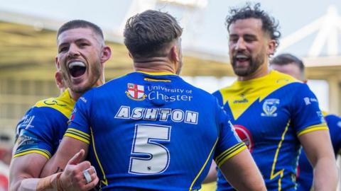 Matty Ashton celebrates his try for Warrington with Danny Walker