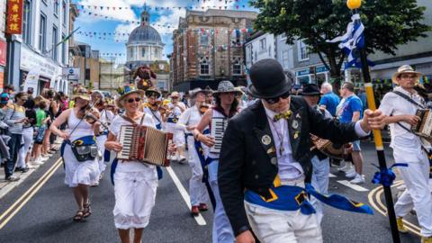 Tom White leading the Golowan Band in the Mazey Day parade part of the Golowan Festival in Penzance in Cornwall in the UK.