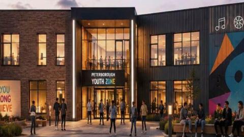 An artist impression of the youth zone. A large double-storey modern building with large glass windows on both floors. There are a number of young people outside and inside. Above the front door is a large sign reading "Peterborough Youth Zone". 