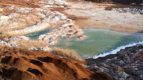 A vast open-pit mine stretches across the landscape on February 12, 2025 in Donetsk Region, Ukraine.