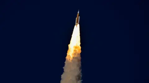 Spacecraft seen against dark skies, shooting up into the air