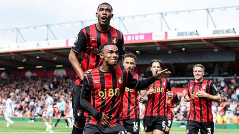 Rayan jumps on Junior Kroupi's back after his goal against Crystal Palace