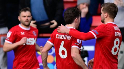 Charlton players celebrate a goal against Exeter