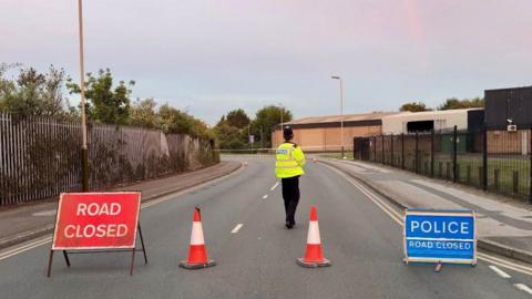 A police officer stands inside the cordon following the incident