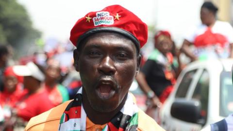 Opposition supporter in a red beret