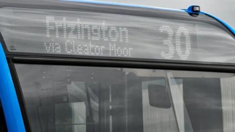 Close view of the front of a bus showing a 30 Frizington via Cleator Moor destination panel