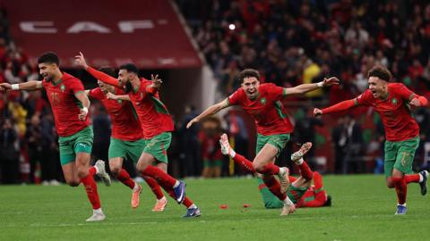 Morocco players celebrate winning a penalty shoot-out in the Africa Cup of Nations semi-final