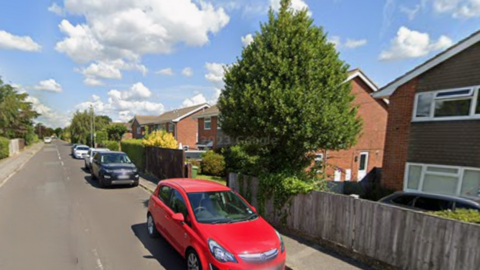Cars parked in Church Road, Warsash - a residential street with two-storey semi-detached houses